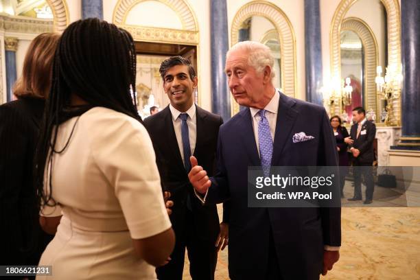 Britain's King Charles III and Britain's Prime Minister Rishi Sunak guests as he hosts a Global Investment Summit reception at Buckingham Palace on...