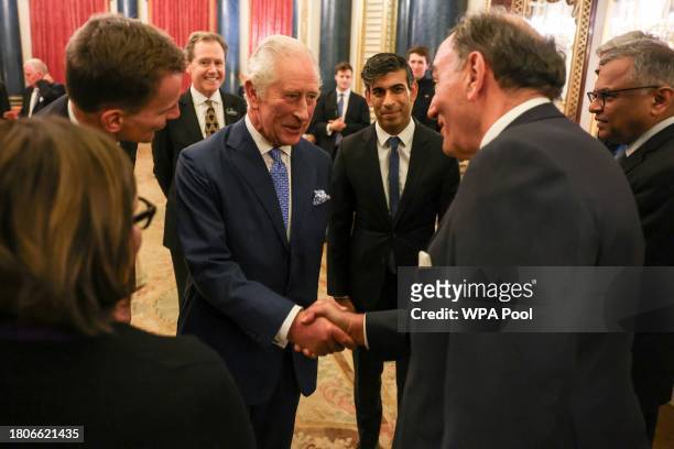 Britain's King Charles III and Britain's Prime Minister Rishi Sunak meet guests as he hosts a Global Investment Summit reception at Buckingham Palace...