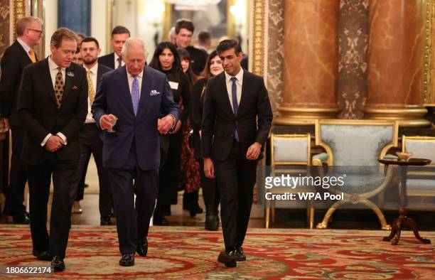 Britain's King Charles III arrives with Britain's Prime Minister Rishi Sunak as he hosts a reception at Buckingham Palace on November 27, 2023 in...