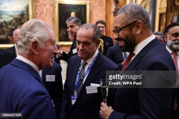 Britain's King Charles III meets with Britain's Home Secretary James Cleverly during a reception at Buckingham Palace on November 27, 2023 in London,...