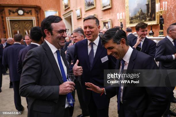 Britain's Prime Minister Rishi Sunak laughs with guests during a reception at Buckingham Palace to mark the conclusion of the Global Investment...