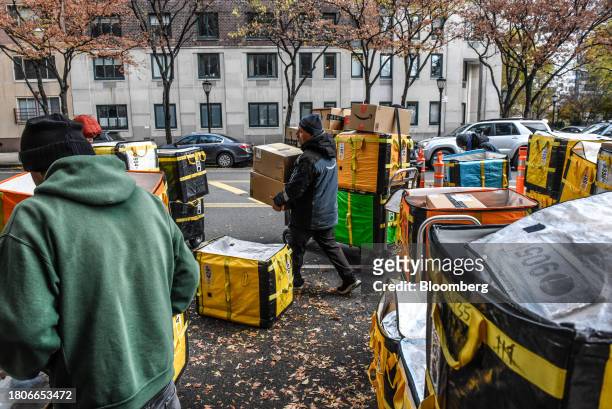 Amazon workers deliver packages on Cyber Monday in New York, US, on Monday, Nov. 27, 2023. An estimated 182 million people are planning to shop from...