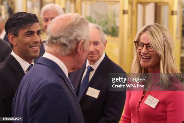 Britain's King Charles III and Britain's Prime Minister Rishi Sunak speak with Chief Executive Officer at Aware Super Pty Ltd Deanne Stewart during a...