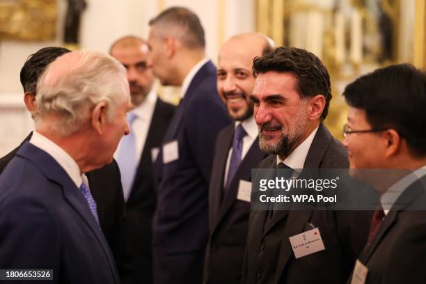 Britain's King Charles III speaks with Chairman of Newcastle United Yasir Al-Rumayyan at a reception at Buckingham Palace to mark the conclusion of...