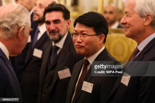 Britain's King Charles III speaks with CEO of Board of the Korea Investment Corporation Seoungho Jin at a reception at Buckingham Palace to mark the...