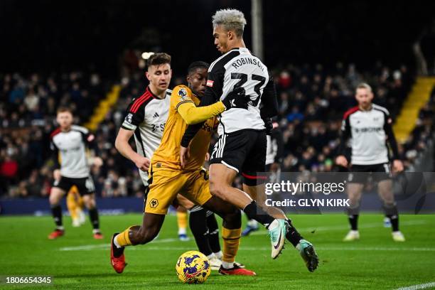 Fulham's Swiss defender Kevin Mbabu fights for the ball with Fulham's English-born US defender Antonee Robinson during the English Premier League...