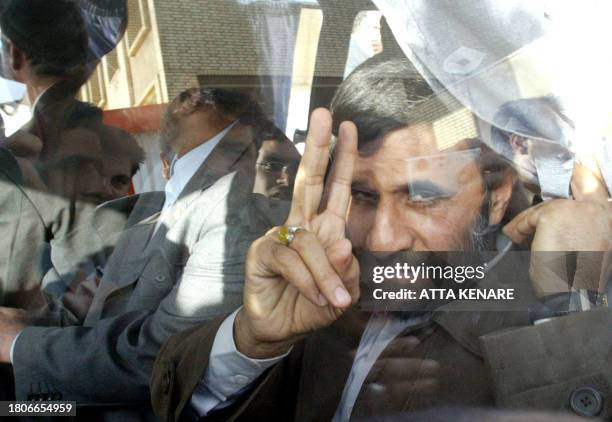 Iranian President Mahmoud Ahmadinejad greets photographers after a ceremony at Natanz uranium enrichment facility some 300 kms, south of the capital...