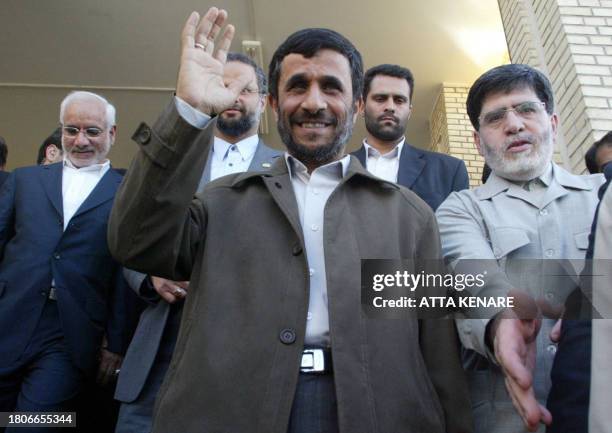 Iranian President Mahmoud Ahmadinejad greets photographers after a ceremony at Natanz uranium enrichment facility some 300 kms, south of the capital...
