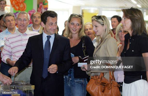 French right-wing UMP presidential candidate Nicolas Sarkozy , flanked by his wife Cecilia , and his stepdaughters Jeanne-Marie and Judith , casts...