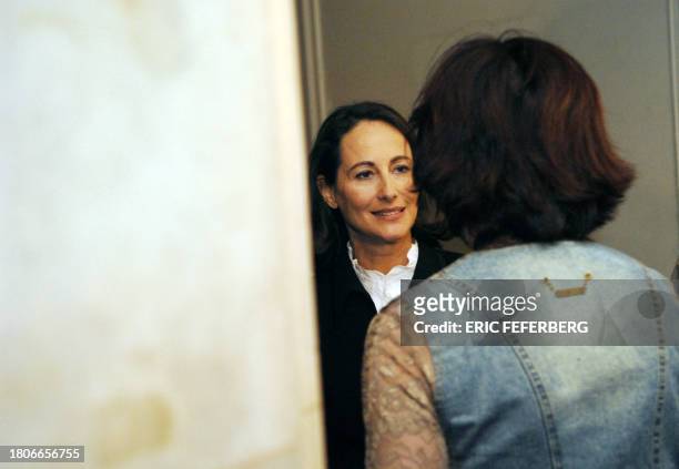 French Socialist Party presidential candidate Segolene Royal , chats with her press officer Agnes Longueville, after she received a petition from a...