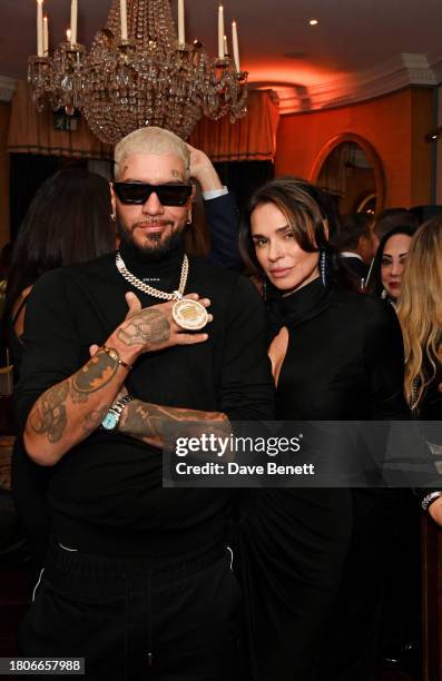 Aka SNIK The Hustla and Celia Kritharioti attend a party celebrating the exclusive launch of Celia Kritharioti at Harrods held at Mark's Club on...