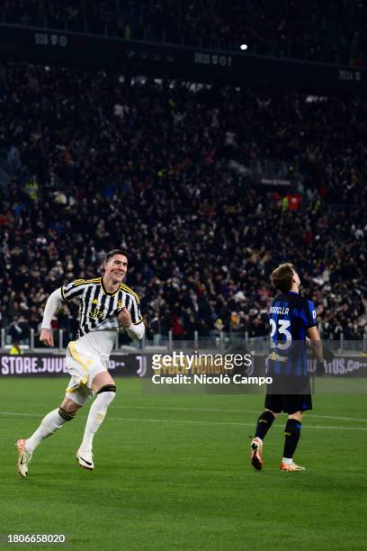 Dusan Vlahovic of Juventus FC celebrates after scoring the opening goal as Nicolo Barella of FC Internazionale looks dejected during the Serie A...