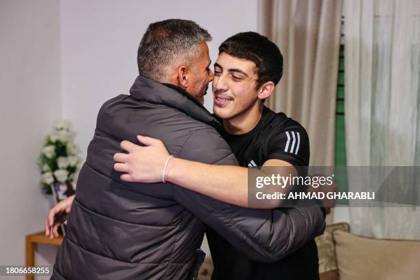 Palestinian Muhammad Abu Al-Humus, former prisoner released from the Israeli jail in exchange for hostages freed by Hamas in Gaza, is greeted by his...