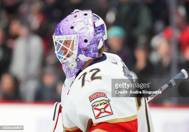 Sergei Bobrovsky of the Florida Panthers skates while wearing a special purple goalie mask on Hockey Fights Cancer night during warmup prior to a...