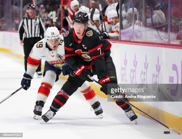 Brady Tkachuk of the Ottawa Senators battles for puck possession against Matthew Tkachuk of the Florida Panthers at Canadian Tire Centre on November...