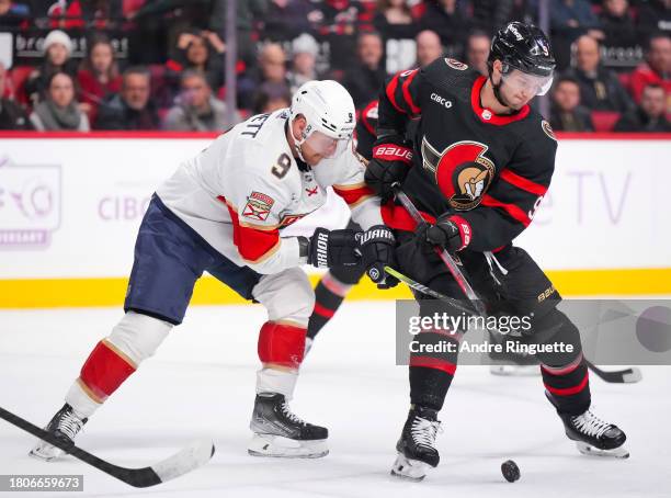Josh Norris of the Ottawa Senators battles for puck possession against Sam Bennett of the Florida Panthers during the first period at Canadian Tire...