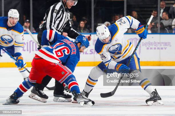 Dylan Cozens of the Buffalo Sabres takes a face-off against Vincent Trocheck of the New York Rangers at Madison Square Garden on November 27, 2023 in...