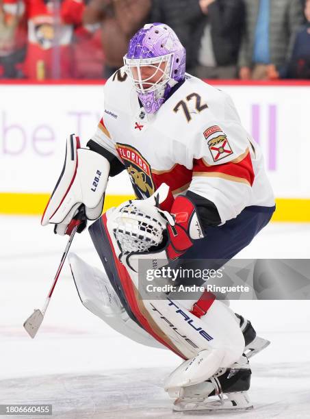 Sergei Bobrovsky of the Florida Panthers skates while wearing a special purple goalie mask on Hockey Fights Cancer night during warmup prior to a...