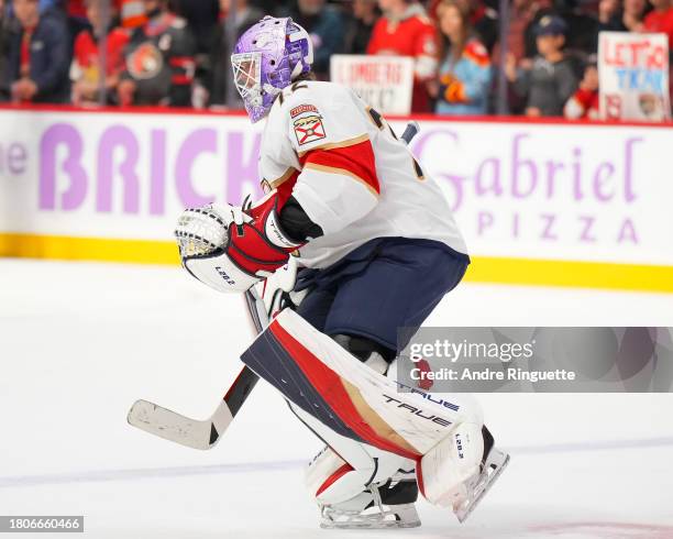 Sergei Bobrovsky of the Florida Panthers skates while wearing a special purple goalie mask on Hockey Fights Cancer night during warmup prior to a...