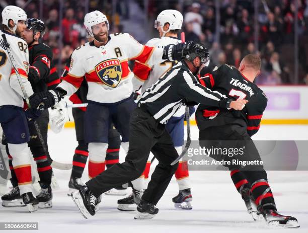 Brady Tkachuk of the Ottawa Senators tries to get back into a scrum as Aaron Ekblad of the Florida Panthers laughs at the end of the second period at...