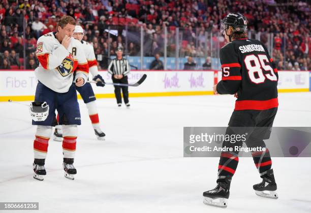 Matthew Tkachuk of the Florida Panthers takes off his helmet as he prepares to fight against Jake Sanderson of the Ottawa Senators during the third...