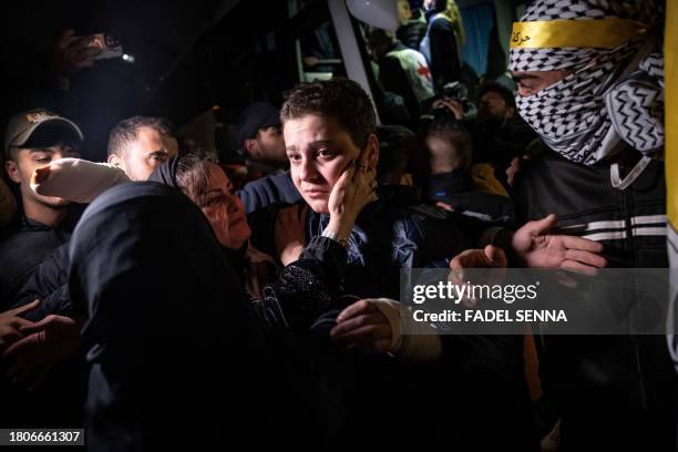 Palestinian prisoner reacts after being released from an Israeli jail in exchange for Israeli hostages released by Hamas from the Gaza Strip,, in the...