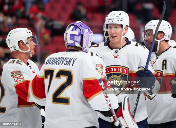 Niko Mikkola of the Florida Panthers congratulates Sergei Bobrovsky after their teams' 5-0 against the Ottawa Senators at Canadian Tire Centre on...