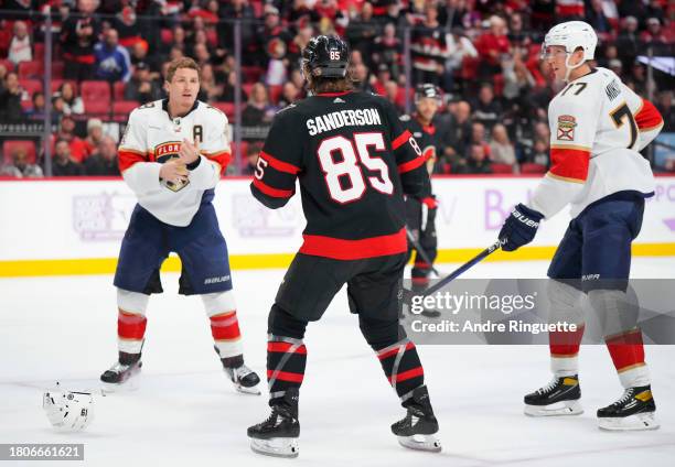 Matthew Tkachuk of the Florida Panthers takes off his helmet as he prepares to fight against Jake Sanderson of the Ottawa Senators during the third...