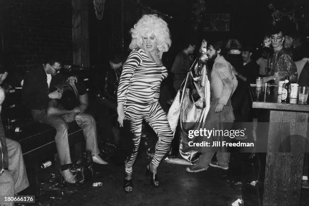 Man in a zebra print body stocking dances in a bar in the West Village, New York City, circa 1982.