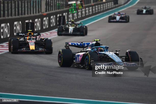 Esteban Ocon of Alpine, Sergio Perez of Red Bull Racing and Lewis Hamilton of Mercedes during the Formula 1 Abu Dhabi Grand Prix at Yas Marina...