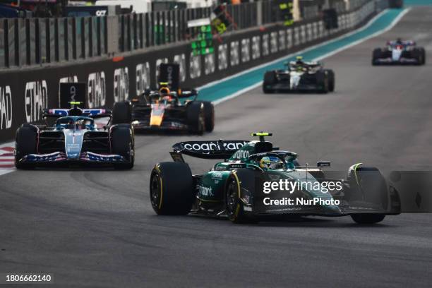 Fernando Alonso of Aston Martin Aramco, Esteban Ocon of Alpine and Sergio Perez of Red Bull Racing during the Formula 1 Abu Dhabi Grand Prix at Yas...