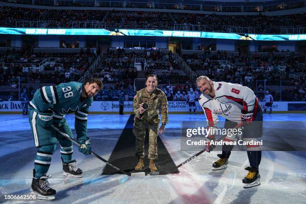 November 27: Mario Ferraro of the San Jose Sharks with Alex Ovechkin of the Washington Capitals at center ice for a ceremonial puck drop at SAP...