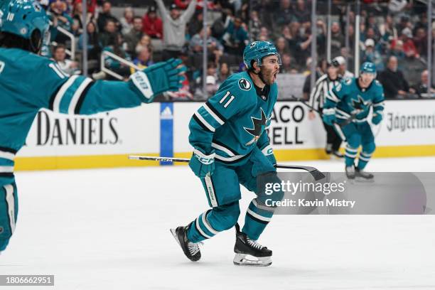 Luke Kunin of the San Jose Sharks celebrates scoring a goal against the Washington Capitals at SAP Center on November 27, 2023 in San Jose,...