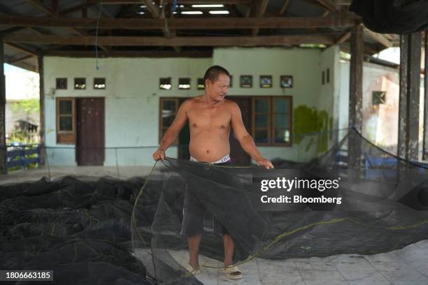 Fisherman checks his net at Tanah Kuning village near The Kalimantan Industrial Park Indonesia in Bulungan Regency, North Kalimantan, Indonesia, on...