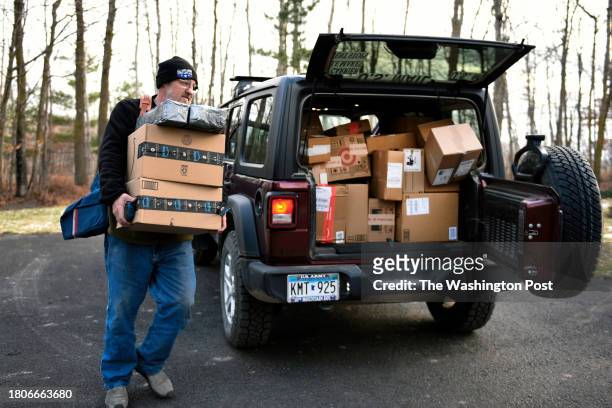 Rural mail carrier Dennis Nelson delivering Amazon packages to a home in remote northern Minnesota on November 25, 2023. The Bemidji Post Office has...