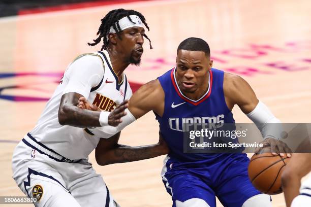 Clippers guard Russell Westbrook drives on Denver Nuggets guard Kentavious Caldwell-Pope during the Denver Nuggets game versus the Los Angeles...