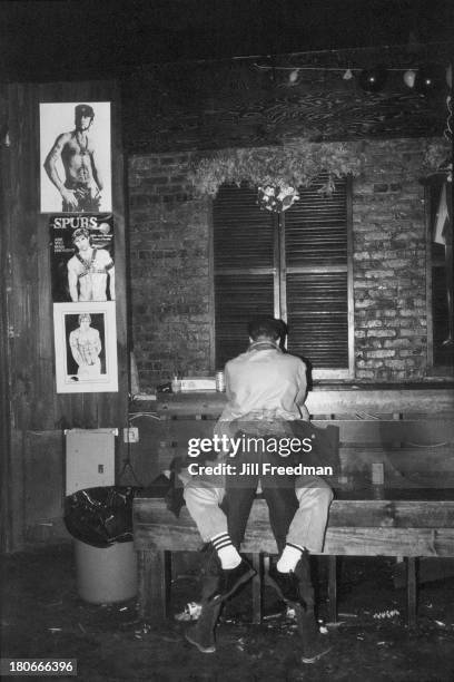 Two men embrace in a gay bar in the West Village, New York City, circa 1980.