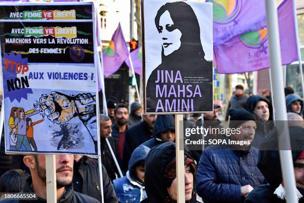 During the demonstration, a Kurdish female protester holds a placard with an image of the young Iranian Kurdish woman, Jina Mahsa Amini beaten to...