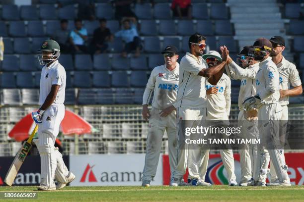 New Zealand's cricketers celebrate after the dismissal of Bangladesh's Mahmudul Hasan Joy during the first day of the first Test cricket match...