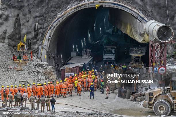 National Disaster Response Force personnel along with other rescue operatives gather near the face of the collapsed under construction Silkyara...