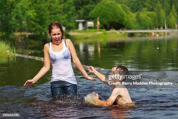 woman and boy playing in the water - finland happy stock pictures, royalty-free photos & images