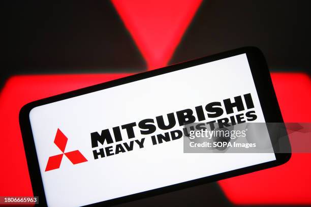 In this photo illustration, Mitsubishi Heavy Industries logo is seen on a smartphone screen.