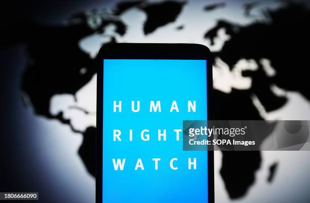 In this photo illustration, Human Rights Watch logo is seen on a smartphone screen.