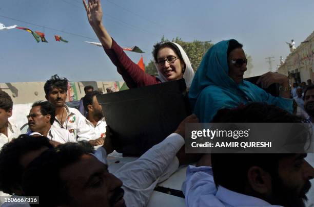 Former Pakistani prime minister Benazir Bhutto waves to her supporters outside her house at her ancestral village Naudero, 27 October 2007. Thousands...