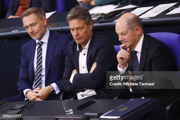 German Chancellor Olaf Scholz , Economy and Climate Action Vice Chancellor Robert Habeck and Finance Minister Christian Lindner listen during the...