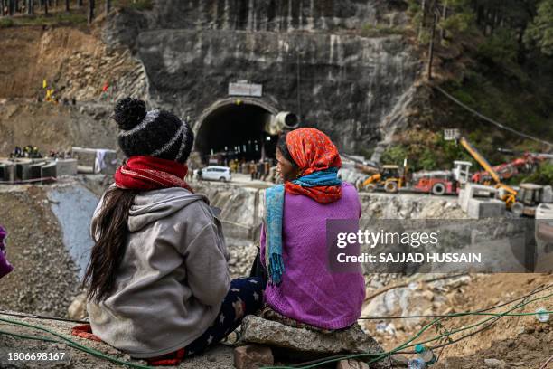 Villagers and locals gather to look at the efforts by the operatives to rescue the 41 men trapped inside the collapsed under construction Silkyara...