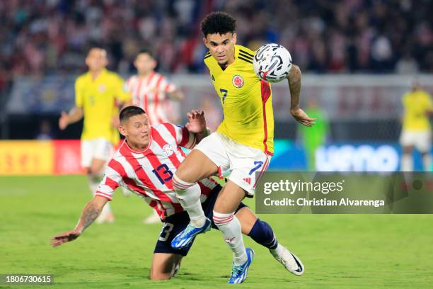 Luis Diaz of Colombia drives the ball past Juan José Cáceres of Paraguay during a FIFA World Cup 2026 Qualifier match between Paraguay and Colombia...