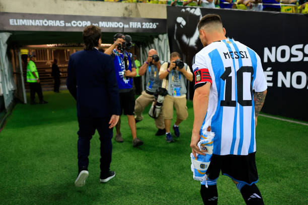 Lionel Messi of Argentina leaves the pitch into the dressing room as the match was delayed due to incidents in the stands during a FIFA World Cup...