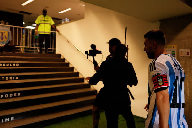 Lionel Messi of Argentina leaves the pitch into the dressing room as the match was delayed due to incidents in the stands during a FIFA World Cup...