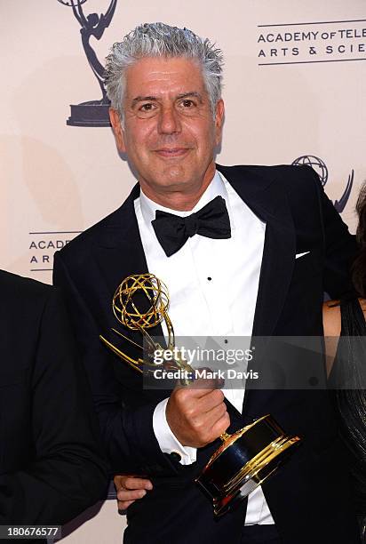 Television host Anthony Bourdain poses with the award for outstanding informational series or special in "Parts Unknown" during the 2013 Creative...